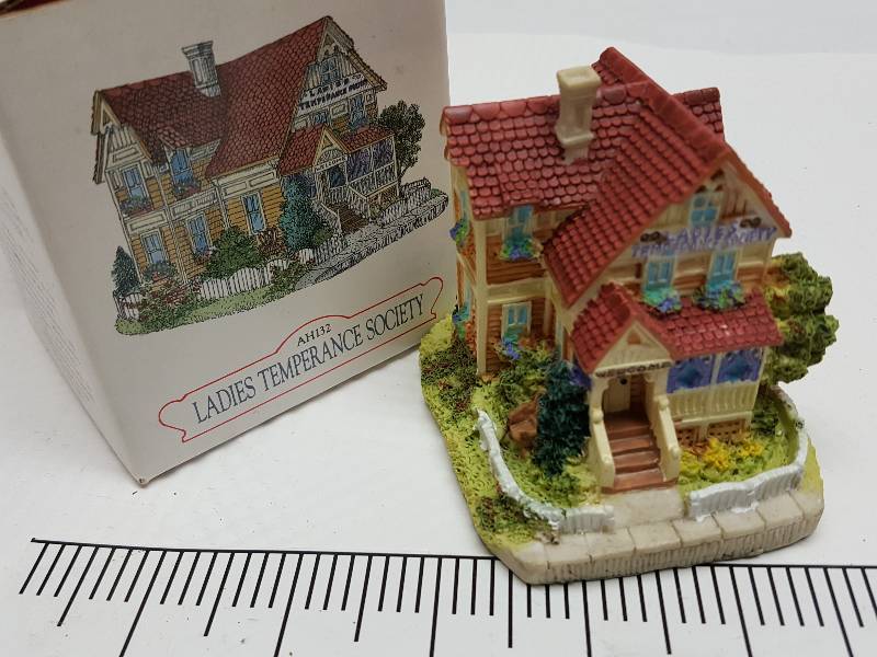 lot 8466 image: Ceramic table top piece sold by Dillards in the 90s as a collectable depicting shops from Liberty Falls