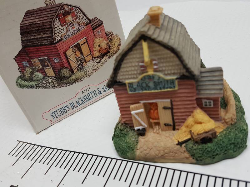 lot 8467 image: Ceramic table top piece sold by Dillards in the 90s as a collectable depicting shops from Liberty Falls