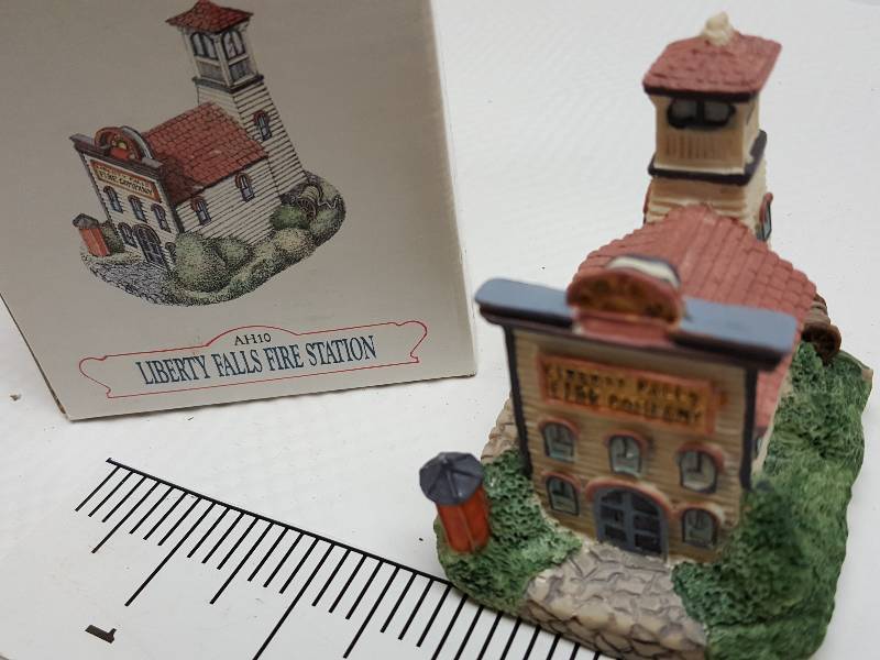 lot 8469 image: Ceramic table top piece sold by Dillards in the 90s as a collectable depicting shops from Liberty Falls