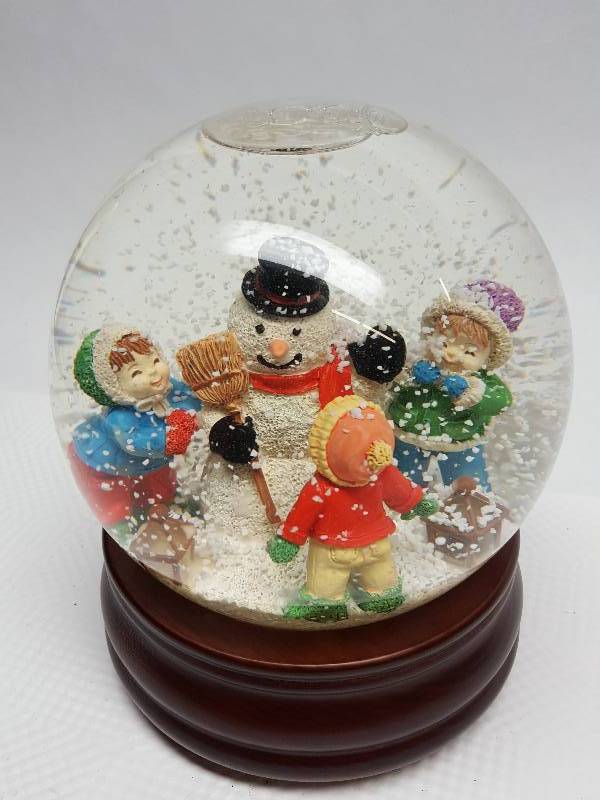 lot 8380 image: Cool looking Snowfall globe with wind up music on a wood base.  Plays Frosty the Snow Man.
