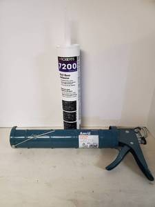 lot 1674 image: Large Caulk Gun and Large Tube of New Floor Adhesive