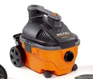 lot 3695 image: RIDGID 15L (4 Gal.) 5.0 Peak HP Portable WetDry Shop Vacuum with Large Rear Wheels & Storage, Orange, Black, 19 x 17