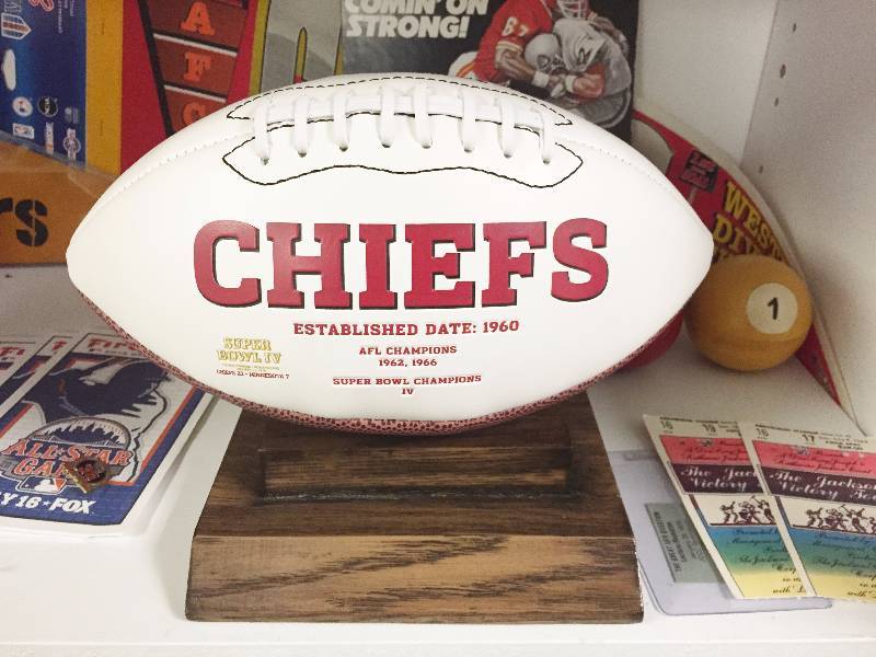lot 1043 image: Awesome Kansas City Chiefs History Full Size Football - Leather Imprinting  Large Sewn on Patch w Wooden Display - Absolutely Beautiful Piece - Must See