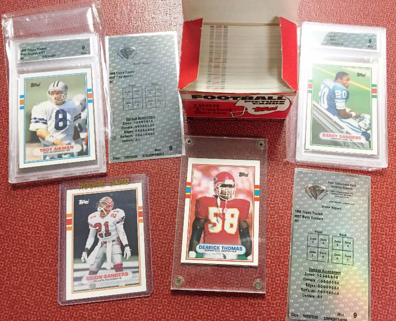 lot 1037 image: 1989 Topps Traded Football Set - Graded Rookies of Barry Sanders, Troy Aikman,   1st Ever Derrick Thomas & Deion Sanders Rookie Cards - Must See
