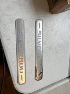 lot 1887 image: Two short and 2 long Chevy Silverado emblems