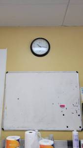lot 10371 image: 4ft x 3ft White Board, Wall-Mount Clock and a 3ft White Wire Wall-Mount Shelf 