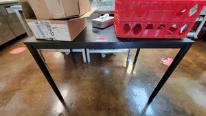 lot 10379 image: 4ft Black Table W Contents