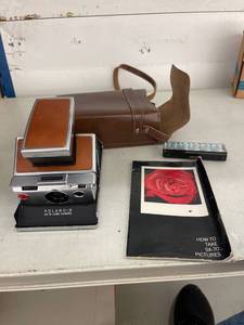 lot 24 image: working Polaroid ax-70 land camera book & case