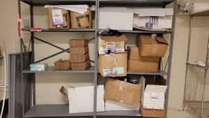 lot 40256 image: Contents of Shelf - 2 Boxes of Antibacterial Wipes, 5 Boxes of Black Masks, 3 Boxes of Hand Sanitizer, and More