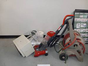 lot 49236 image: Water Hose Reel Dirt Devil Vacuum and a Ceiling Heater