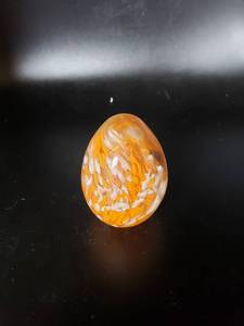 lot 1867 image: orangewhite egg shaped paperweight