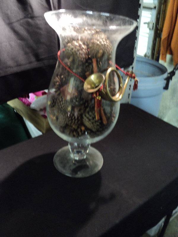 lot 5003 image: Large Glass Vase wscented pine cones and french horn ornament, 9-34 diameter x 20 tall