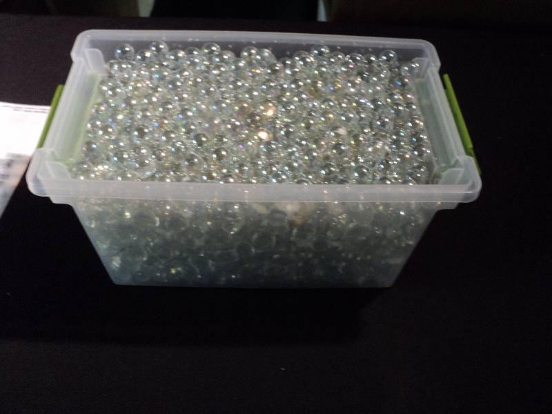 13 lbs. of clear glass marbles and pebbles in plastic container Year
