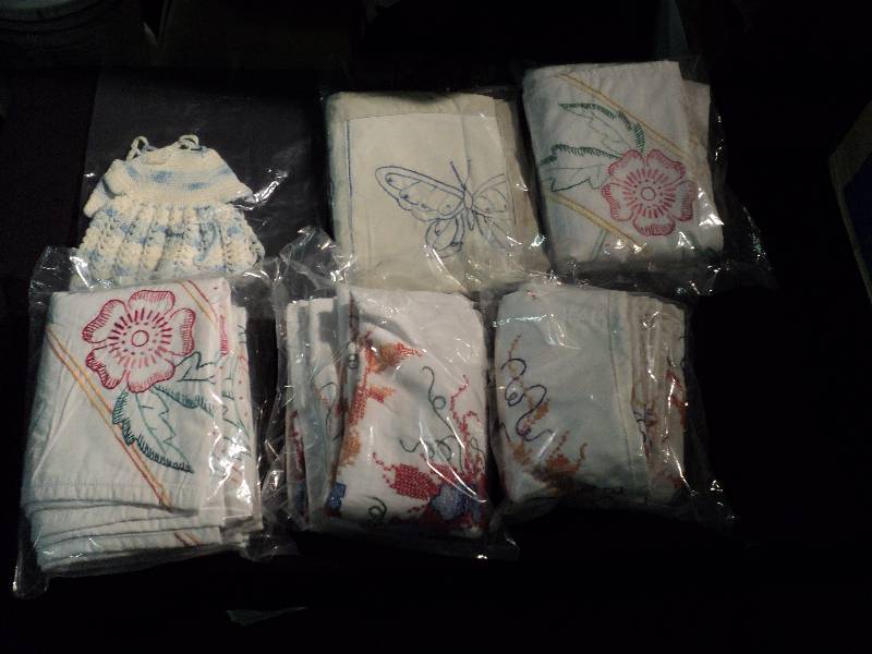 lot 5011 image: (5) ct lot small cross-stitch quilt tops, many styles, all around 44 x 29 and (2) crochet doll dresses