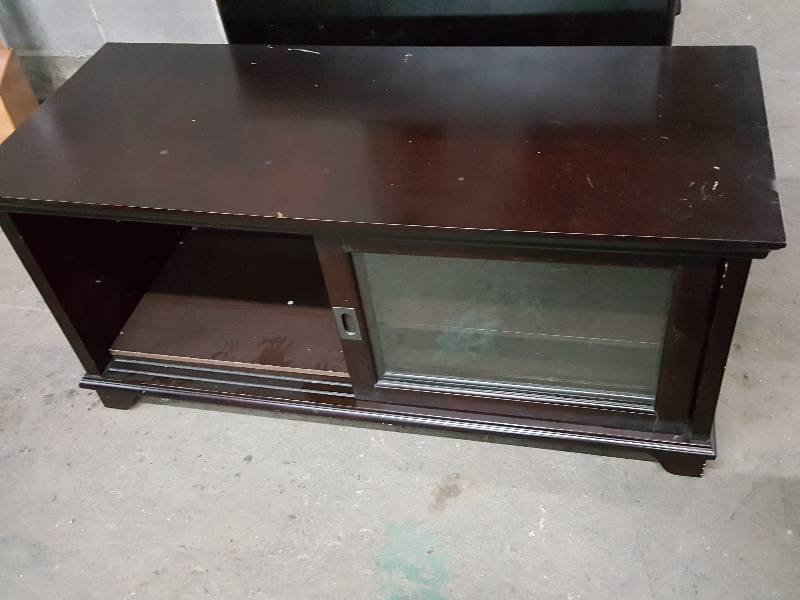 lot 2021 image: Expensive looking TV stand or console with glass sliding doors in the front.