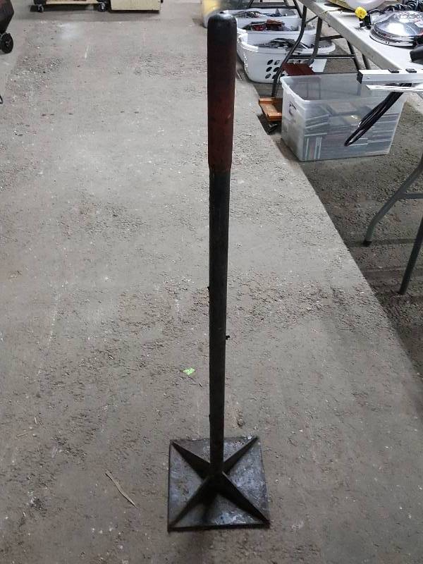 lot 2028 image: This looks like work to me.  12 X 12 steel dirt tamper and 45 tall handle.