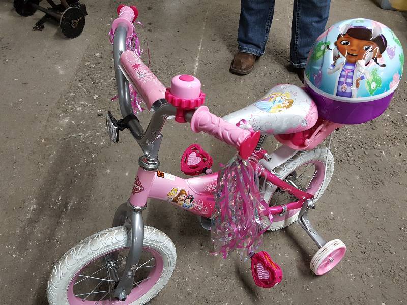 lot 2037 image: No miles or use at all on this 12 Huffy Princess Bicycle.  Included is the Doc McStuffin helmet