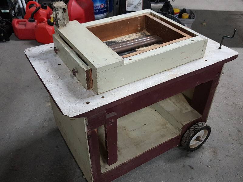 lot 2050 image: Home made but actually pretty neat is this saw table with wheels and fold up handles with storage drawer.