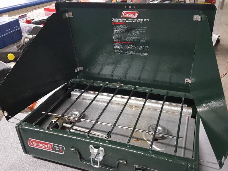 lot 2056 image: Not much use on this Coleman 2 burner camp stove.  Looks complete but you have to furnish your own bottle