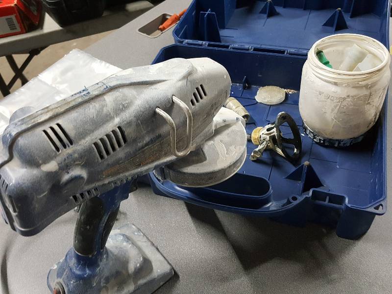 lot 2057 image: Definitely been used is this Made in the USA Graco True Coat paint sprayer kit with storage box