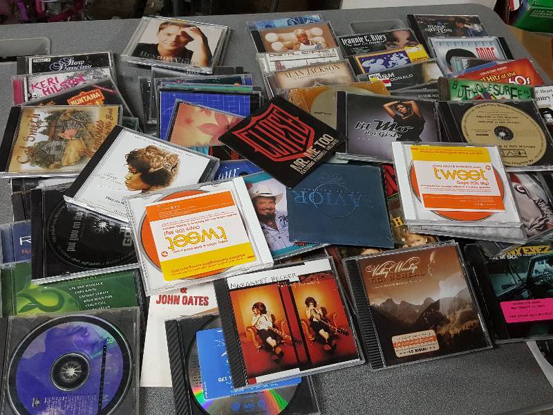 lot 2084 image: Just imagine getting a $$$$ dollar a piece in your flea market boot. Youll make some bucks with this big tote of CDs.