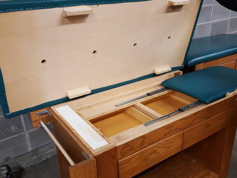 lot 2003 image: Originally a medical exam table with 2 storage drawers and extension.  Quality construction