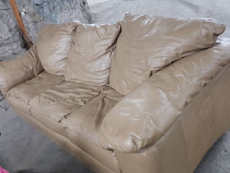 lot 2196 image: Big Tan Faux leather couch with no tears or broken down areas.