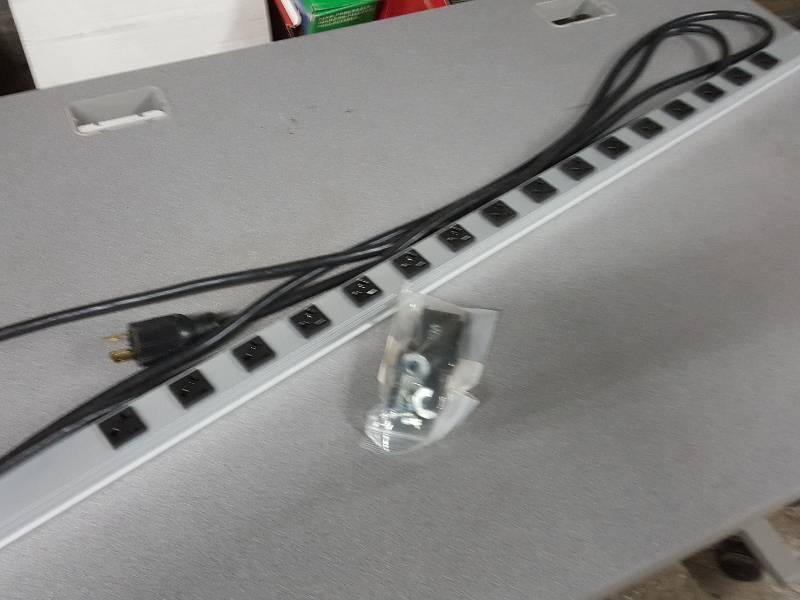 lot 2112 image: 16 position electric power strip with mounting brackets and hardware included.   6-8 foot power cord attached.