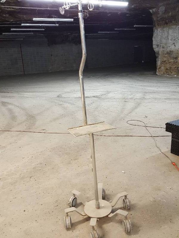 lot 8112 image: Stainless tubing and work tray on this multi position wires, fluid tubing and cords bed side IV bottle stand.