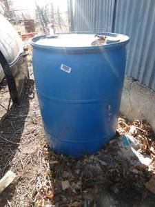 lot 11108 image: Blue Plastic Barrel Partially Full    East of West Barn