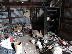 lot 11111 image: Variety of Auto Parts & Tools & Misc  Contents in NE Corner of Barn  Metal Cabinet & Lockers w Contents  Items on Wall and Floor  East 12 of West Barn