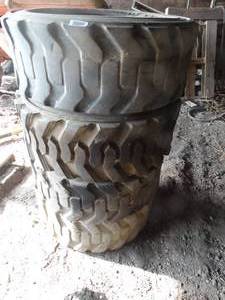 lot 11169 image: Three 12-16.5 NHS Tires    West 12 of West Barn