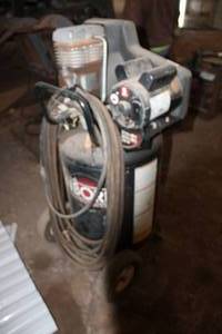 lot 18082 image: Coleman Sanborn Upright Air Compressor