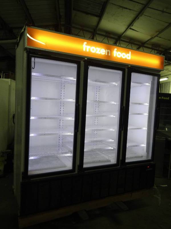 lot 2392 image: Master Bilt 3 Door Glass Front Reach in Freezer With Casters