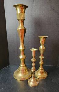 lot 106 image: (3) Brass Candlesticks 12, 15, and 24 (located in basement)