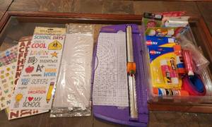 lot 201 image: Tote Full of Scrapbooking Supplies (Paper, Paper Cutter, New Glue Sticks, Stickers, Plastic Page Protectors, and More) - Located in Basement