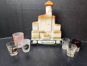 lot 245 image: Vintage Jim Beam Whiskey Decanter of The Broadmoor Hotel 1918-1968 and Shot Glasses (located in basement)