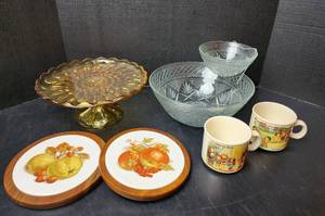 lot 248 image: Amber Glass Cake Plate, Vintage Crystal 3-piece Chip and Dip Set, (2) Campbells Soup Mugs, and Trivets (located in basement)