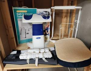 lot 287 image: Medical Supplies and Exercise Equipment (Toilet Rails, Sock Assist, Knee Brace, Back Brace, Shower Stool, Back 2 Life (stretches back), Seat Cushion, and More) located in basement - bring boxes