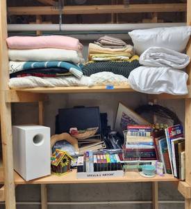 lot 288 image: Contents of 2 Shelves (linens, luggage, books, home decor, holiday decor, scrapbooking albums and photo albums, movies, and much more) Located in Basement - Bring Boxes