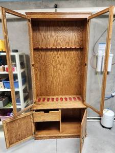 lot 292 image: 2 Piece Oak Gun Cabinet (holds 10 guns) 37x17x80 (see pics for broken glass) Located in Basement