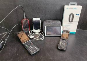 lot 524 image: Fitbit Alta, Garmin Nuvi Navigation (needs cord), and Cell Phones
