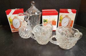 lot 564 image: (2) NIB Fifth Avenue Crystal Century 5.5 Oval Clock, NIB Fifth Avenue Essex 6 Crystal Jar, Crystal Cream and Sugar Dishes, and Other Crystal