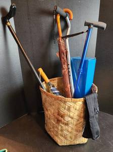 lot 650 image: Basket of (3) Walking Canes, (2) Umbrellas, Size Large Compression Socks 15-20, and 20 Knee Imobilizer