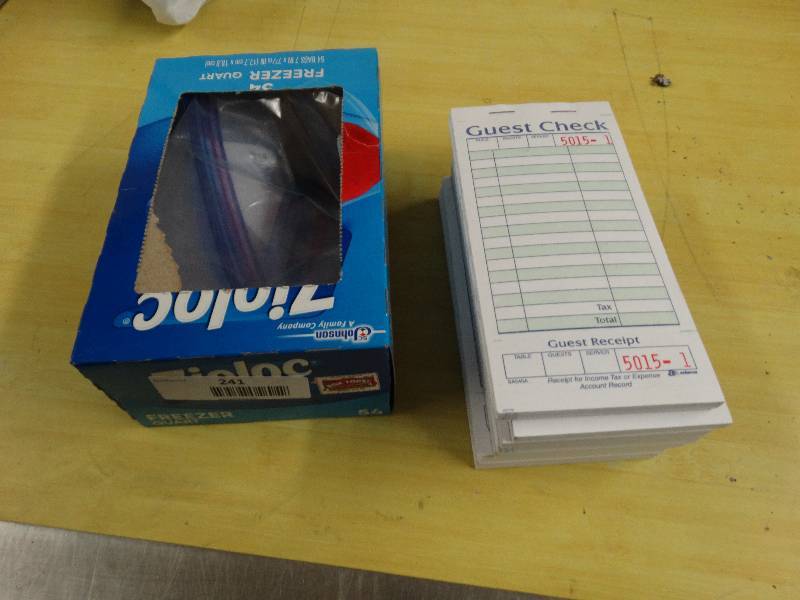 lot 241 image: Partial Box Of Zip lock Bags7 Guest Check Books.