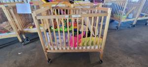 lot 39846 image: Woodem Whitney Fire Safe Crib W Assorted Toys