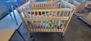 lot 39849 image: Wooden Whitney Evacuation Crib W Assorted Toys