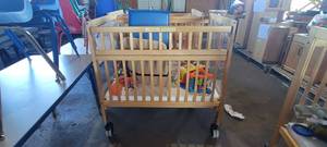 lot 39850 image: Wooden Whitney Evacuation Crib W Assorted Toys