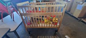 lot 39857 image: Wooden Whitney Evacuation Crib W Assorted Toys