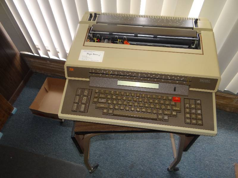 lot 1004 image: Metal Shelf & Royal Electric Typewriter.